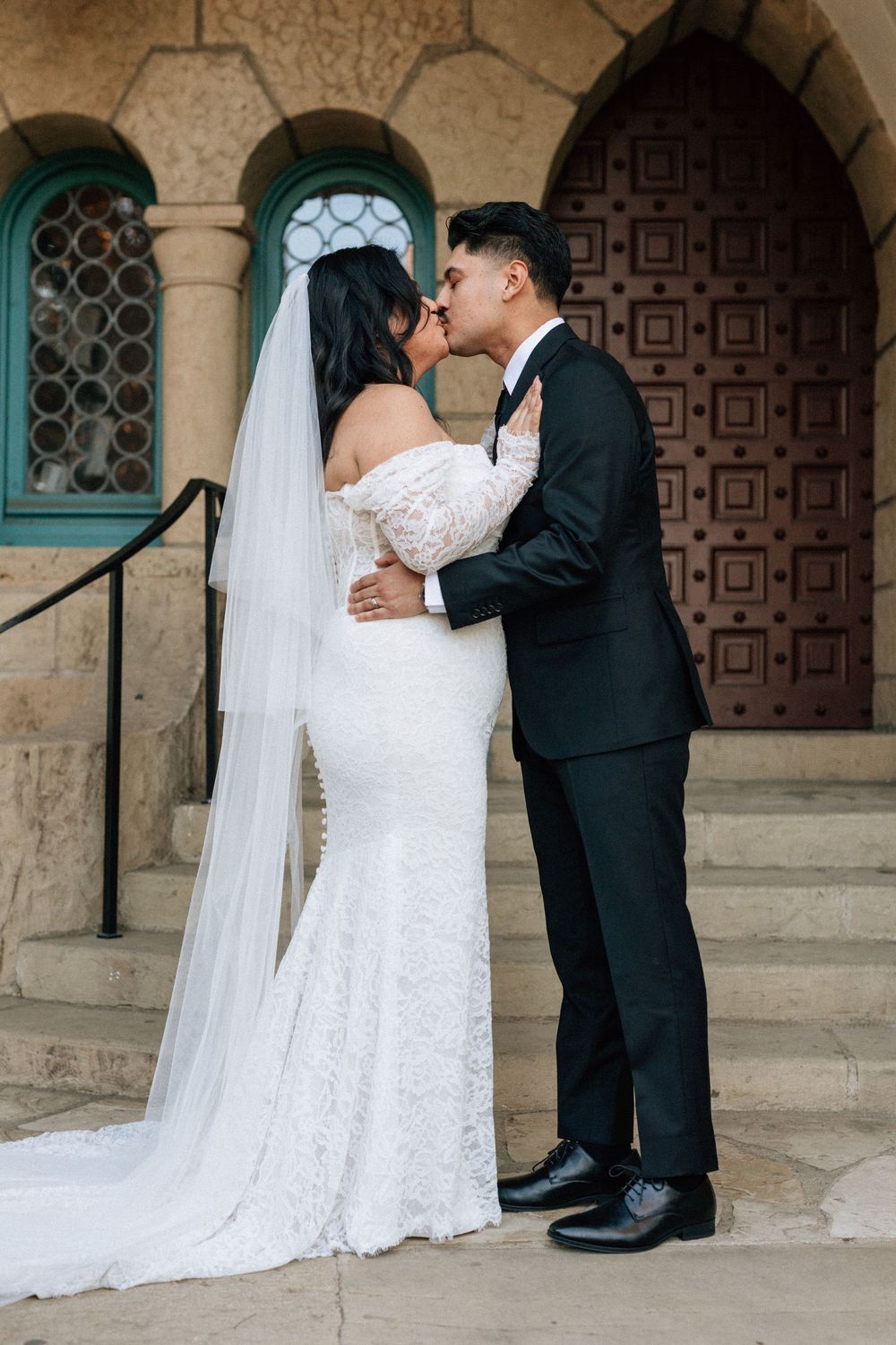 A couple share their first kiss after eloping at the Santa Barbara Courthouse