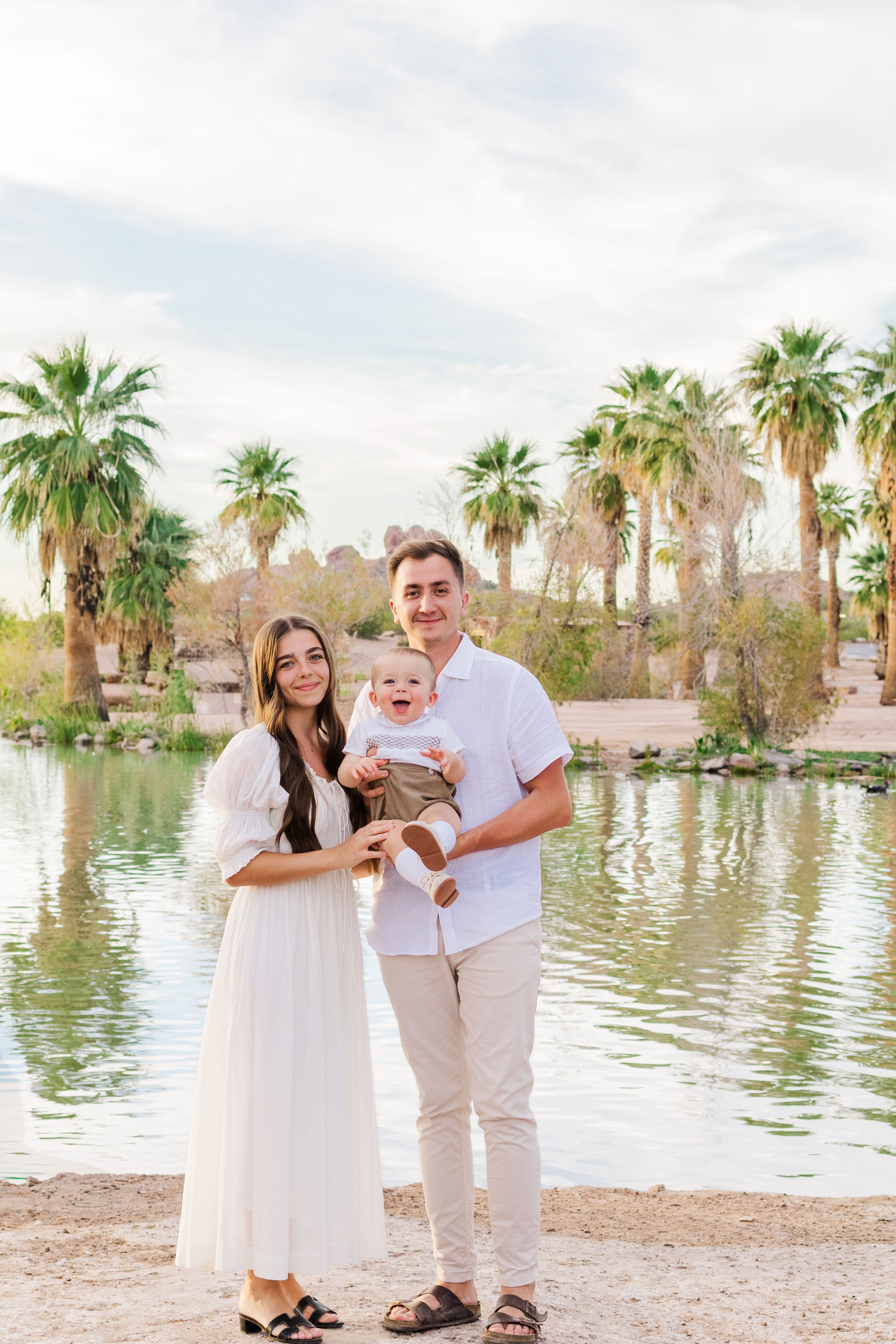 Family of 3 portrait in front of a pond at Papago Park in Phoenix, Arizona.