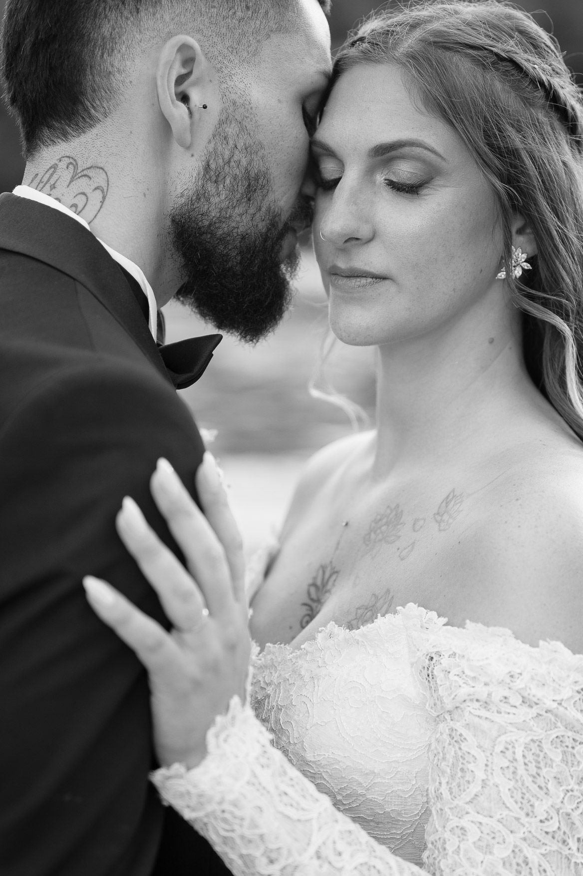 A romantic black and white photo series shows a couple in wedding attire sharing intimate close-up moments.