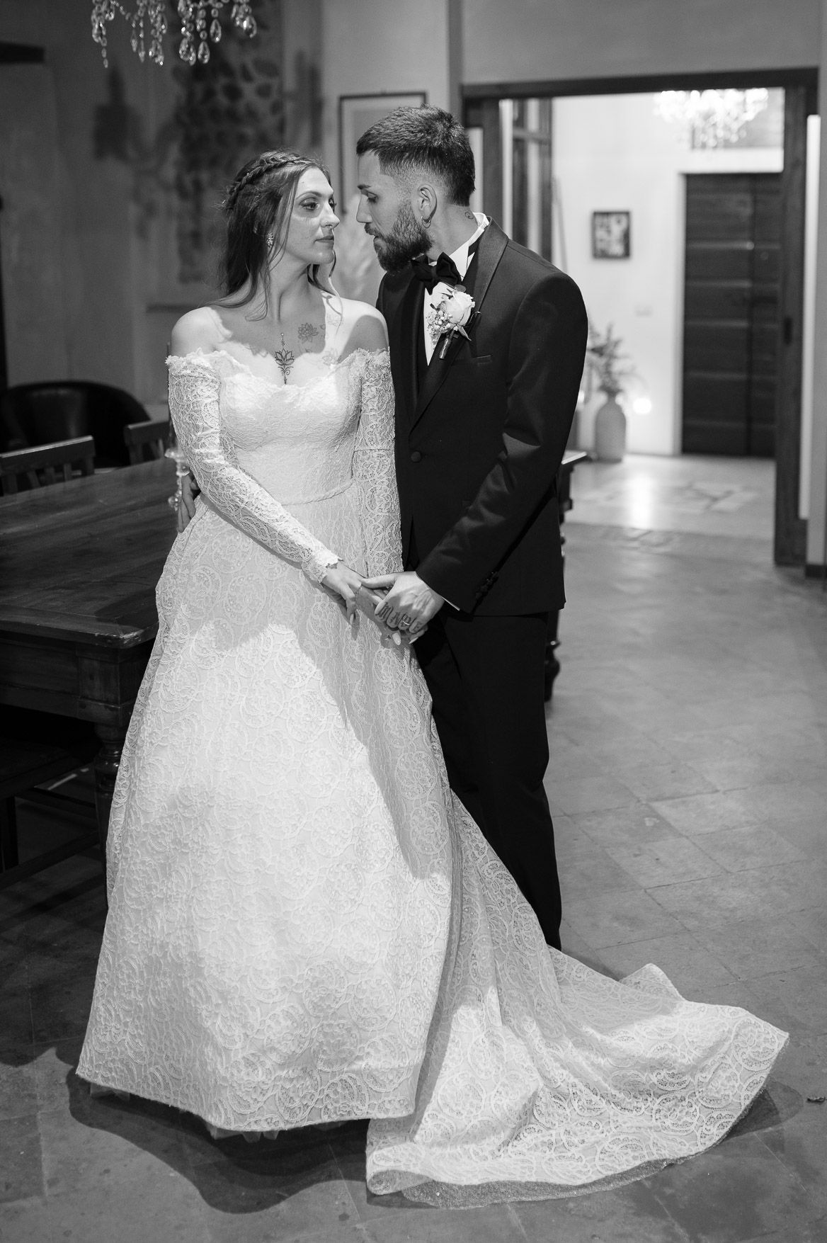 Black and white wedding photos showing a couple dancing in an elegant ballroom setting.