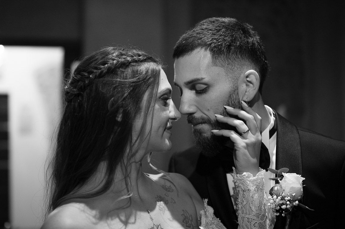 Intimate black and white wedding portraits capture romantic moments between newlyweds.