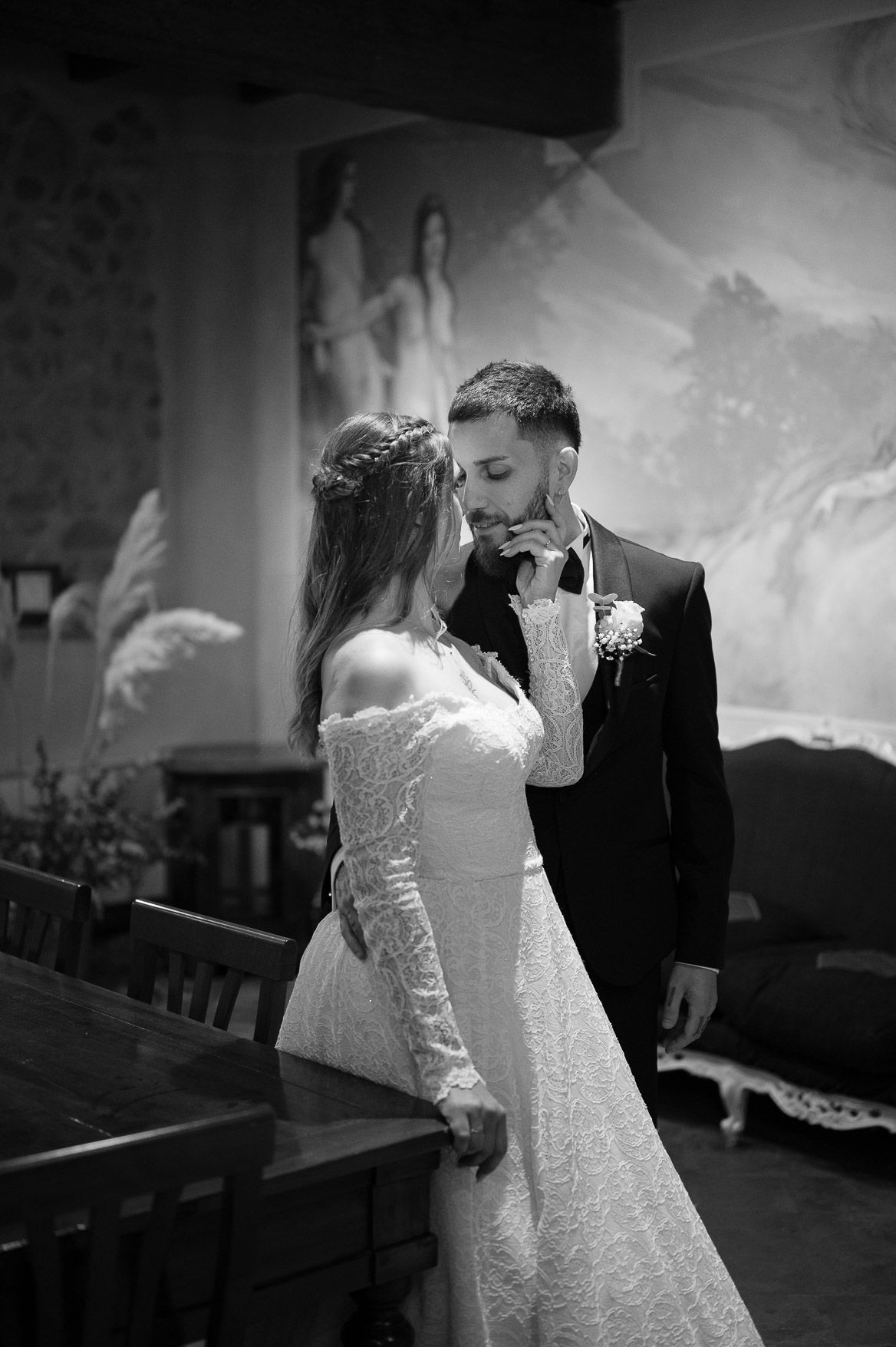 Dramatic black and white wedding photos show tender moments in a church setting.