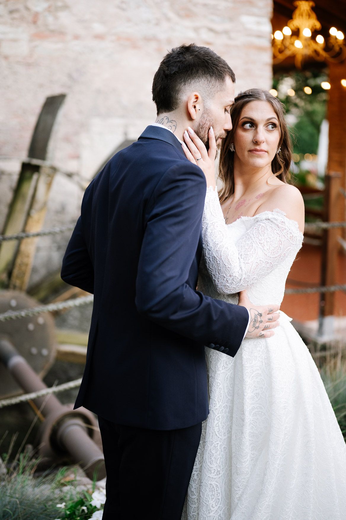 A romantic wedding couple embraces in a series of intimate outdoor portraits at sunset.