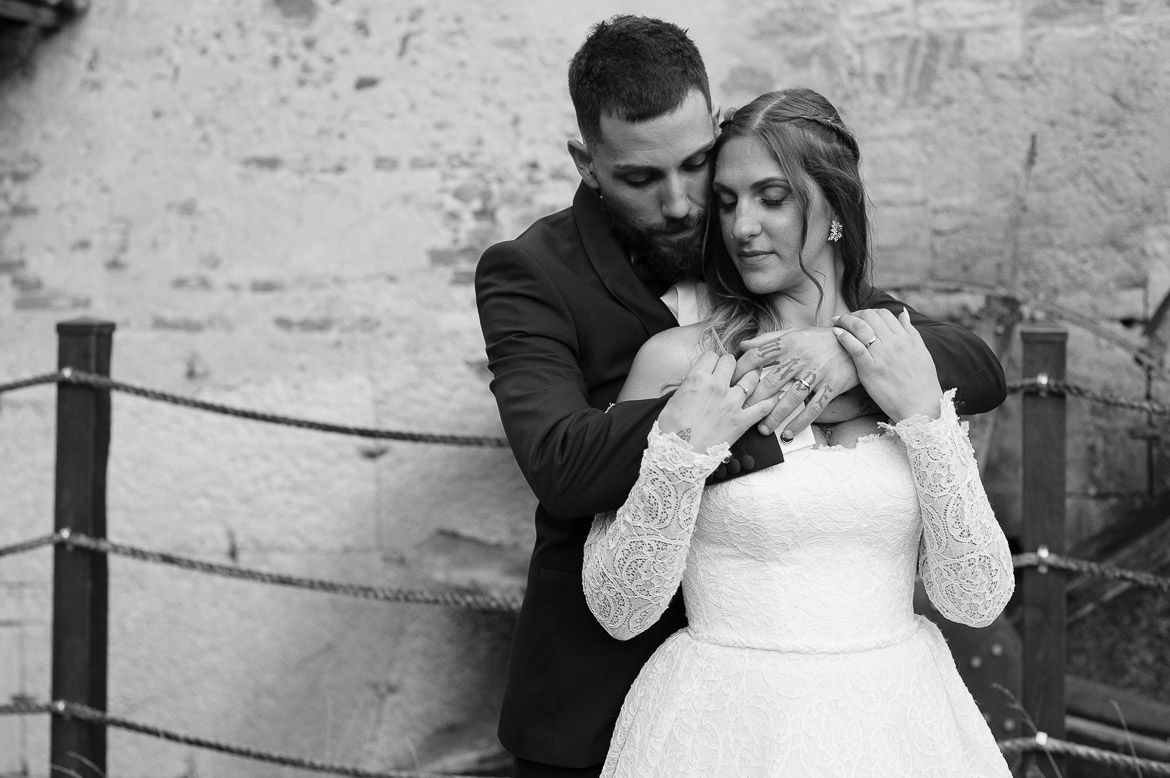 Black and white wedding portraits capturing tender moments between bride and groom.