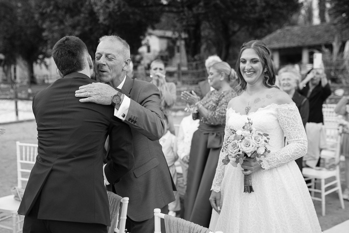 Wedding guests celebrate during an outdoor reception with dancing and laughter.