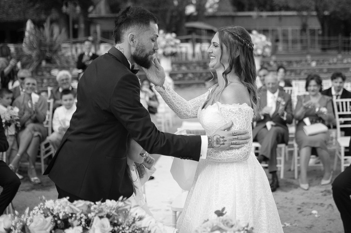 Black and white photos capture candid moments of celebration at an outdoor wedding reception.
