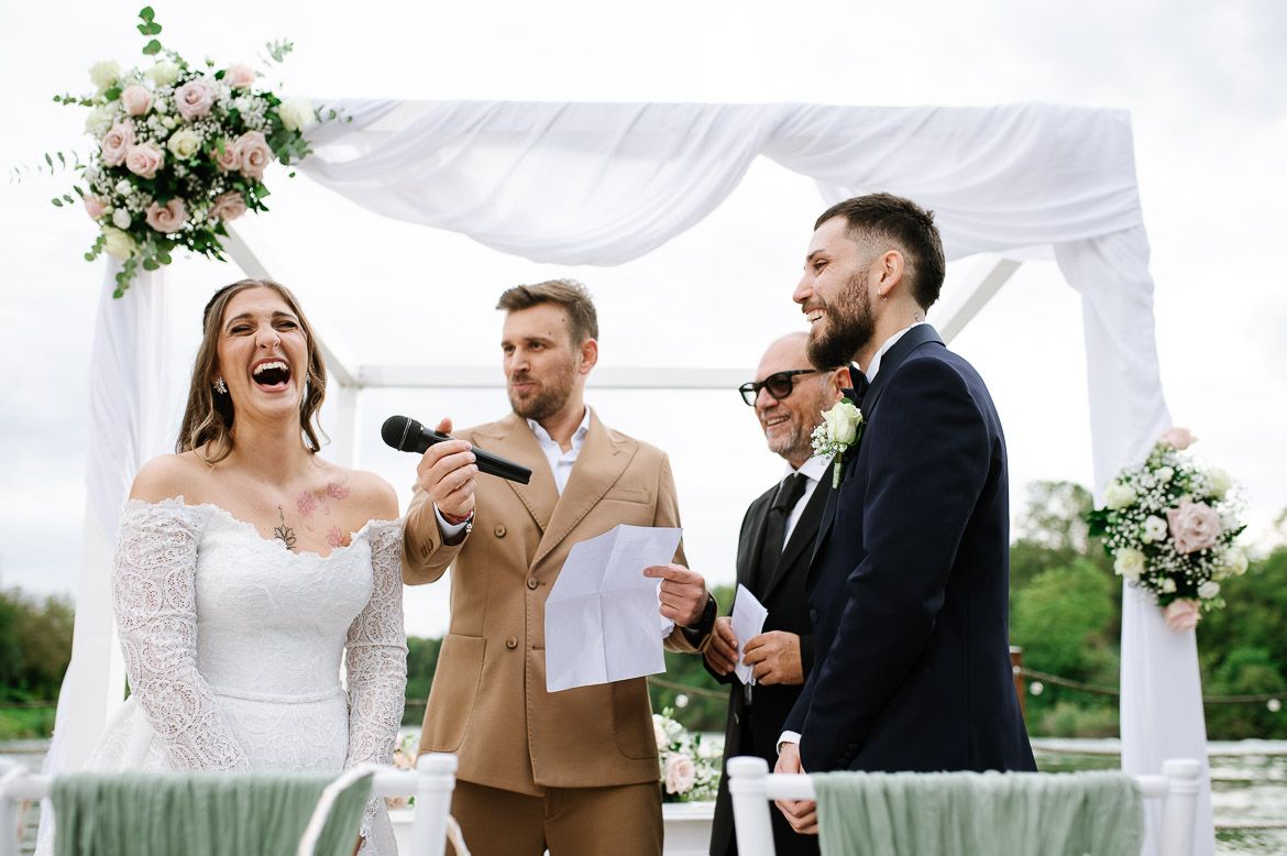 Joyful celebration moments under a white tent at an outdoor wedding reception.