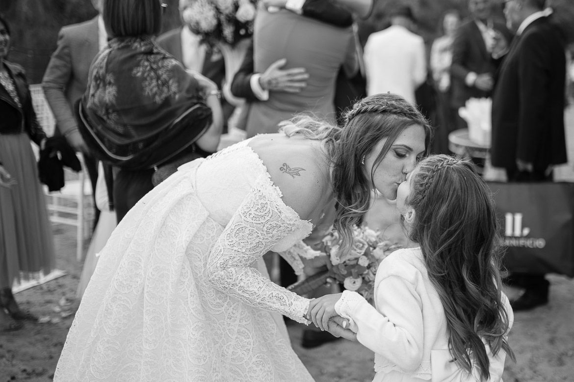 Wedding ceremony guests celebrate with the newlyweds during an outdoor reception.