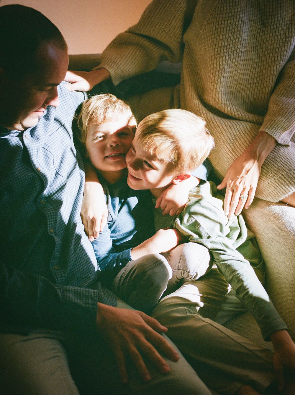 Tender interaction between family members relaxing together on a comfortable sofa.