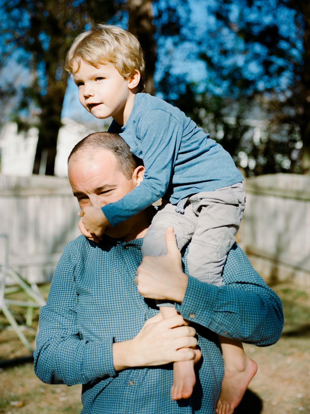 Playful outdoor moment with people in blue checkered clothing.