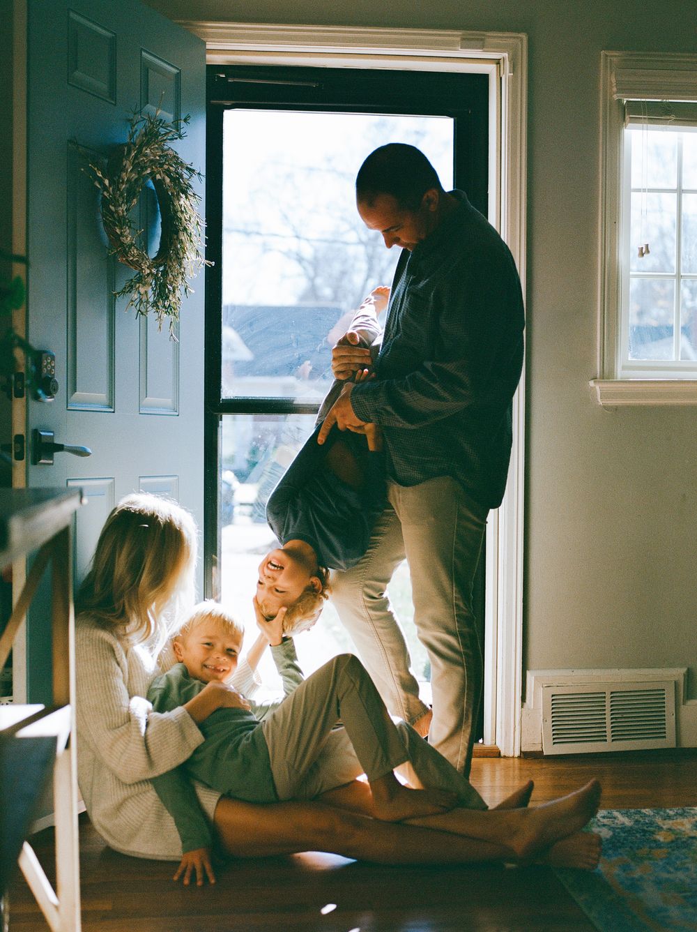 Series of candid indoor moments showing active play and movement near a doorway in natural light.