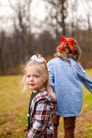 Outdoor autumn scene with plaid and denim clothing against bare trees.