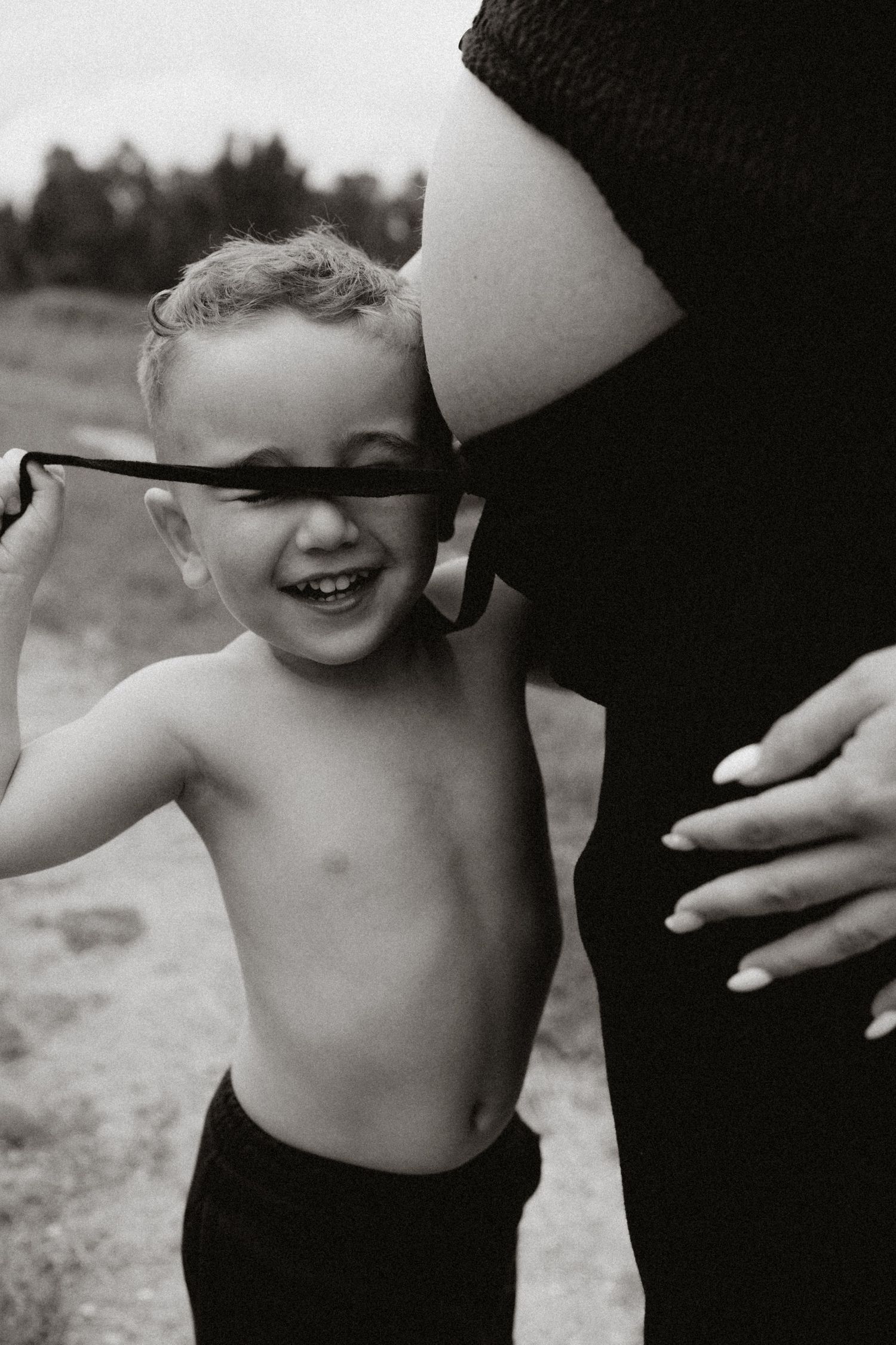 Black and white candid sequence showing playful moments with a child.