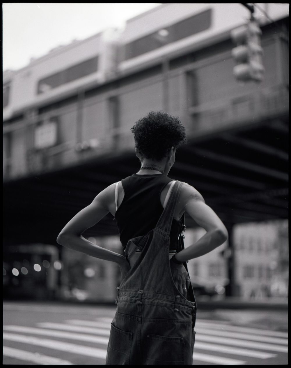 Urban fashion photography in black and white showing dynamic poses against city backdrop.
