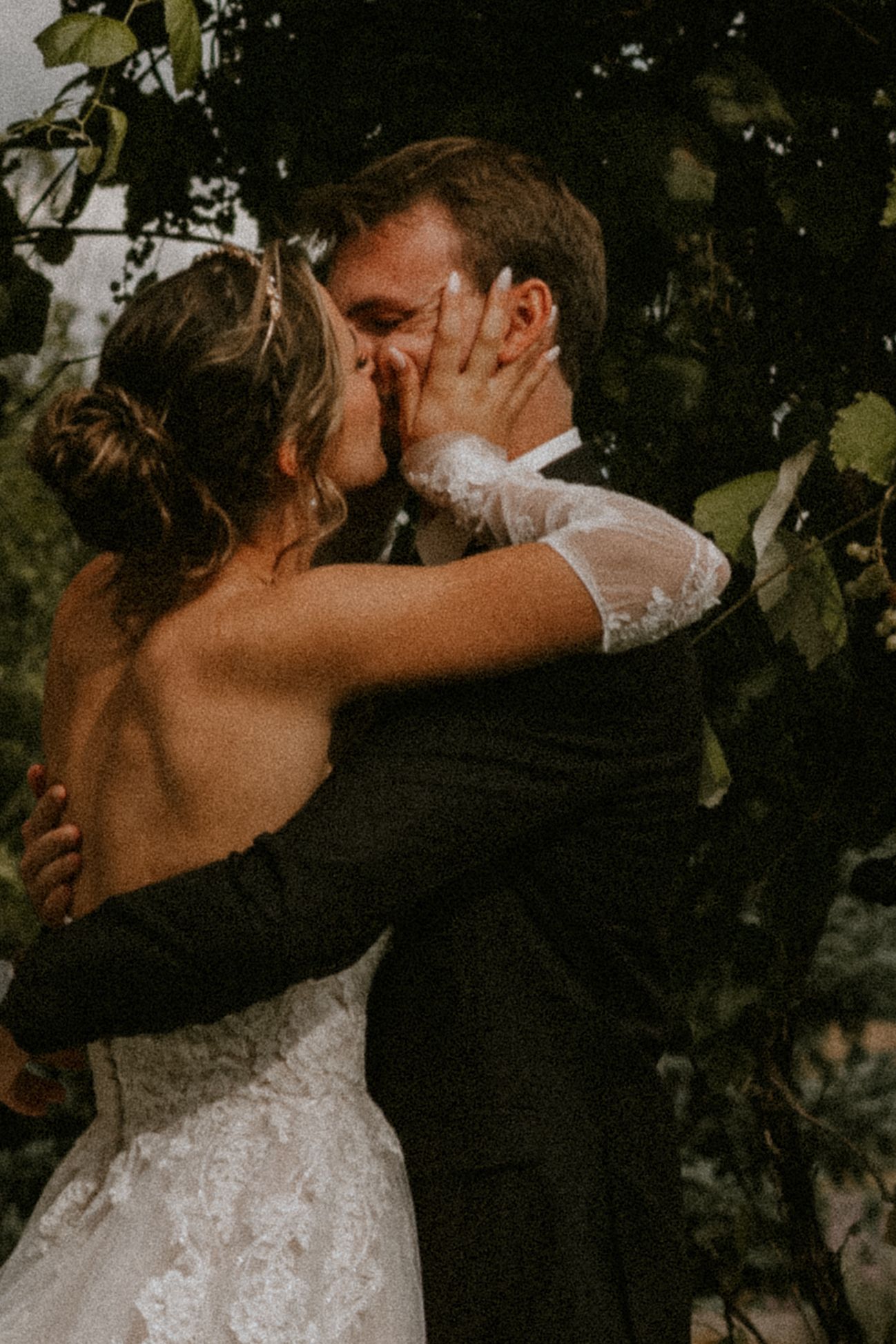 Black and white photo series of a couple in wedding attire walking through a misty field at sunset.