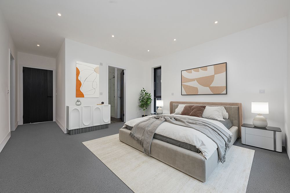 Modern bedroom interior with white walls, recessed lighting, and contemporary artwork displayed on the walls.