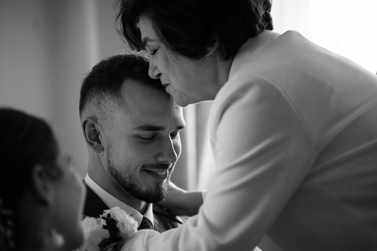 A black and white photo collage showing intimate romantic moments between a couple on their wedding day.
