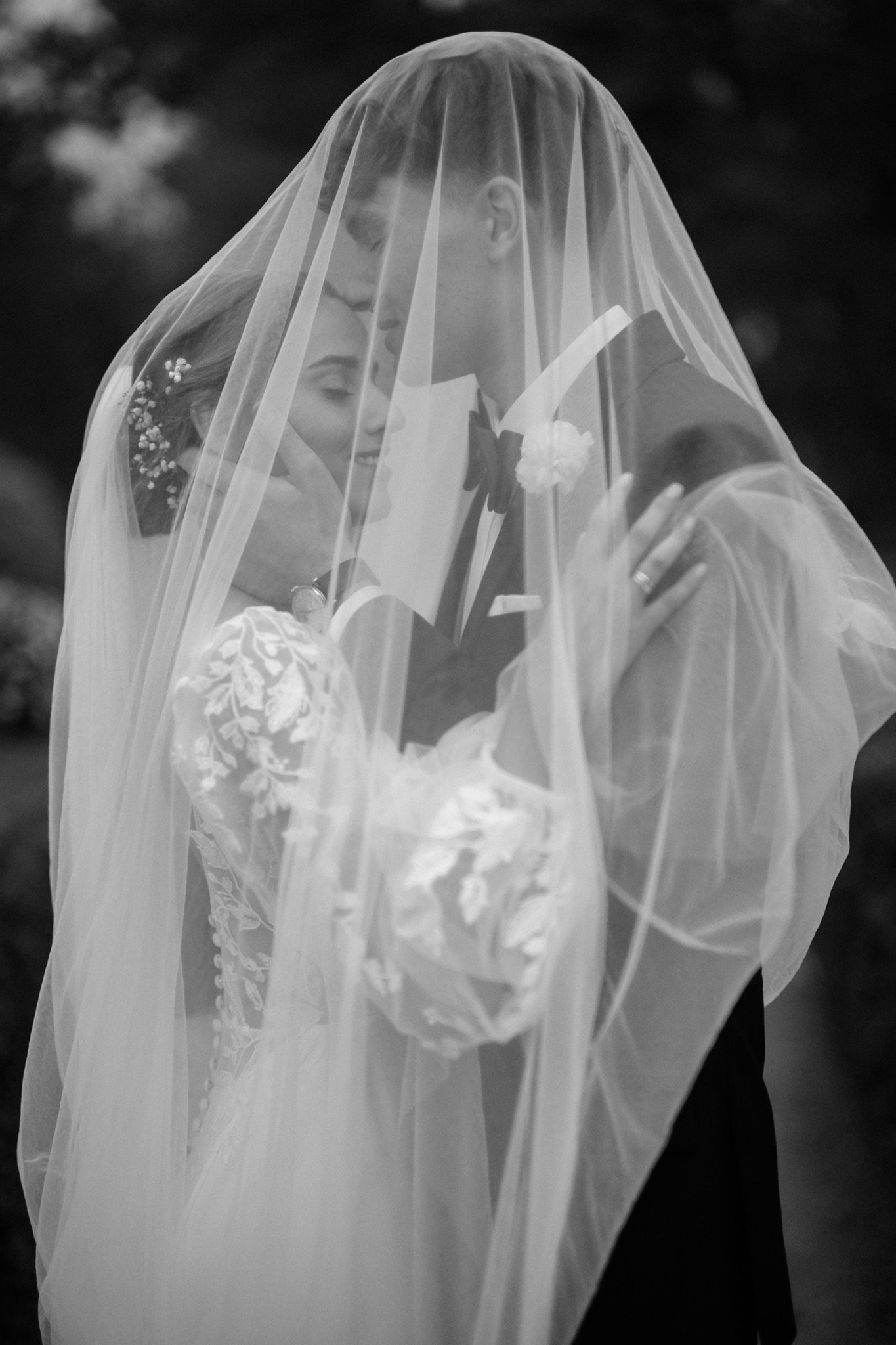A series of black and white photos showing a bride wearing a delicate veil in an artistic sequence.