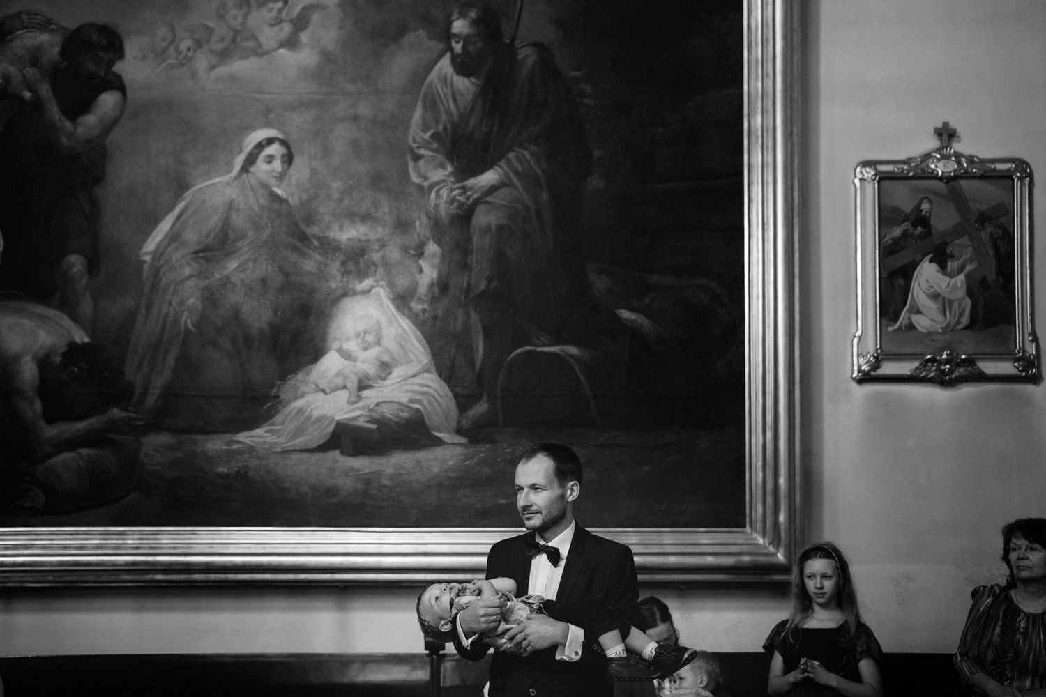 A series of black and white religious paintings and artworks depicting biblical scenes and figures in a gallery setting.