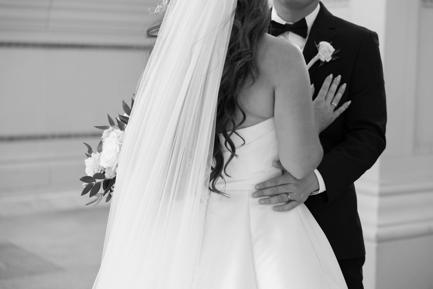A black and white wedding photo collage showing intimate moments between newlyweds with flowing veil and formal attire.