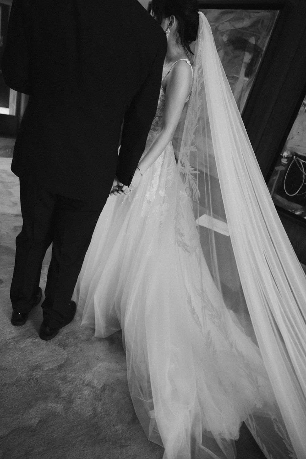 Wedding dress train and veil flowing gracefully across the floor during the ceremony.