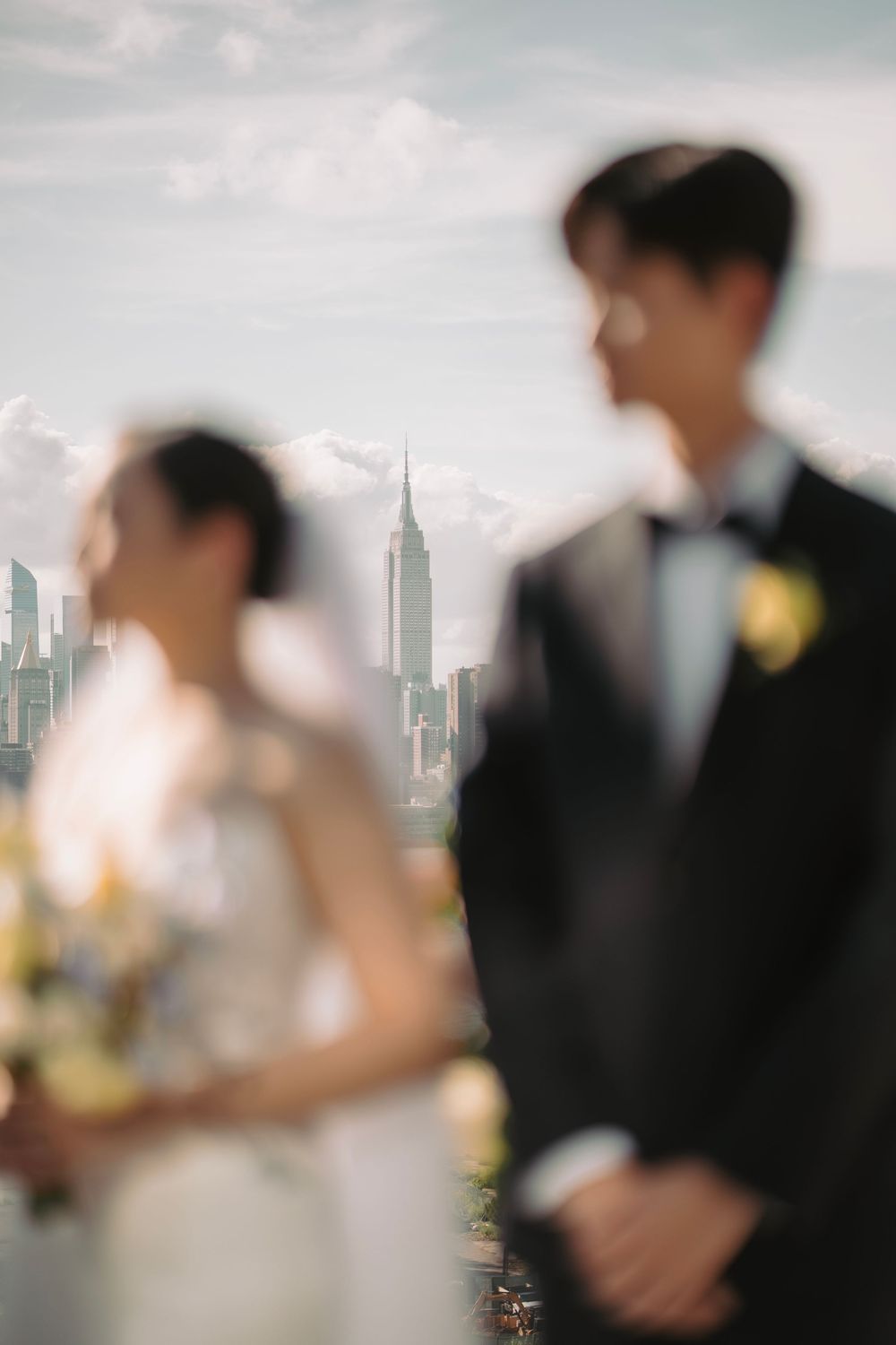 Artistic wedding photo with Empire State Building visible in background.