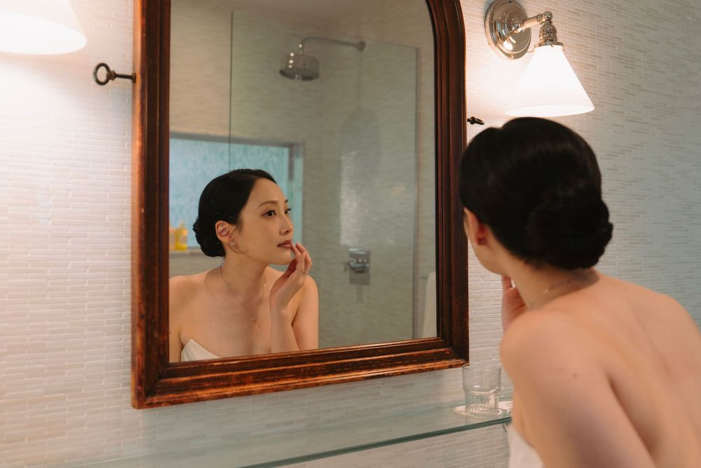 Elegant bathroom mirror reflection showing preparation for special occasion.