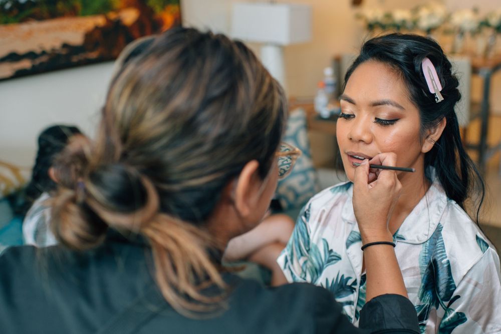Close-up shots of makeup application during wedding day preparations.