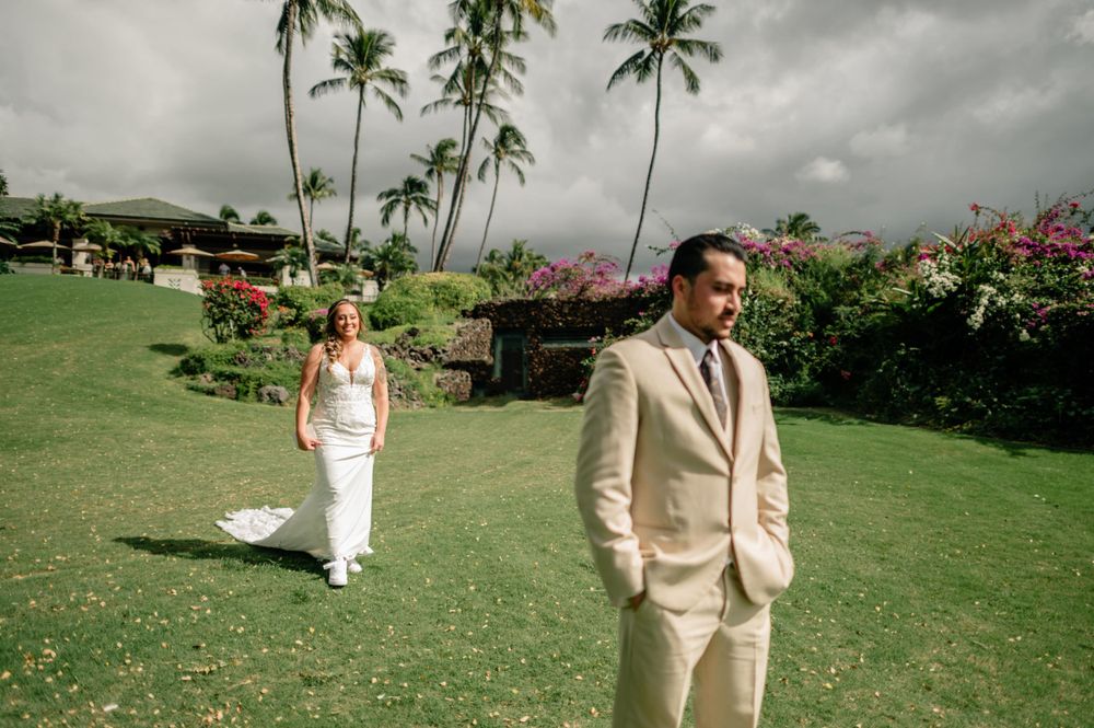 Tropical wedding venue with palm trees and cloudy skies creating a dramatic backdrop.