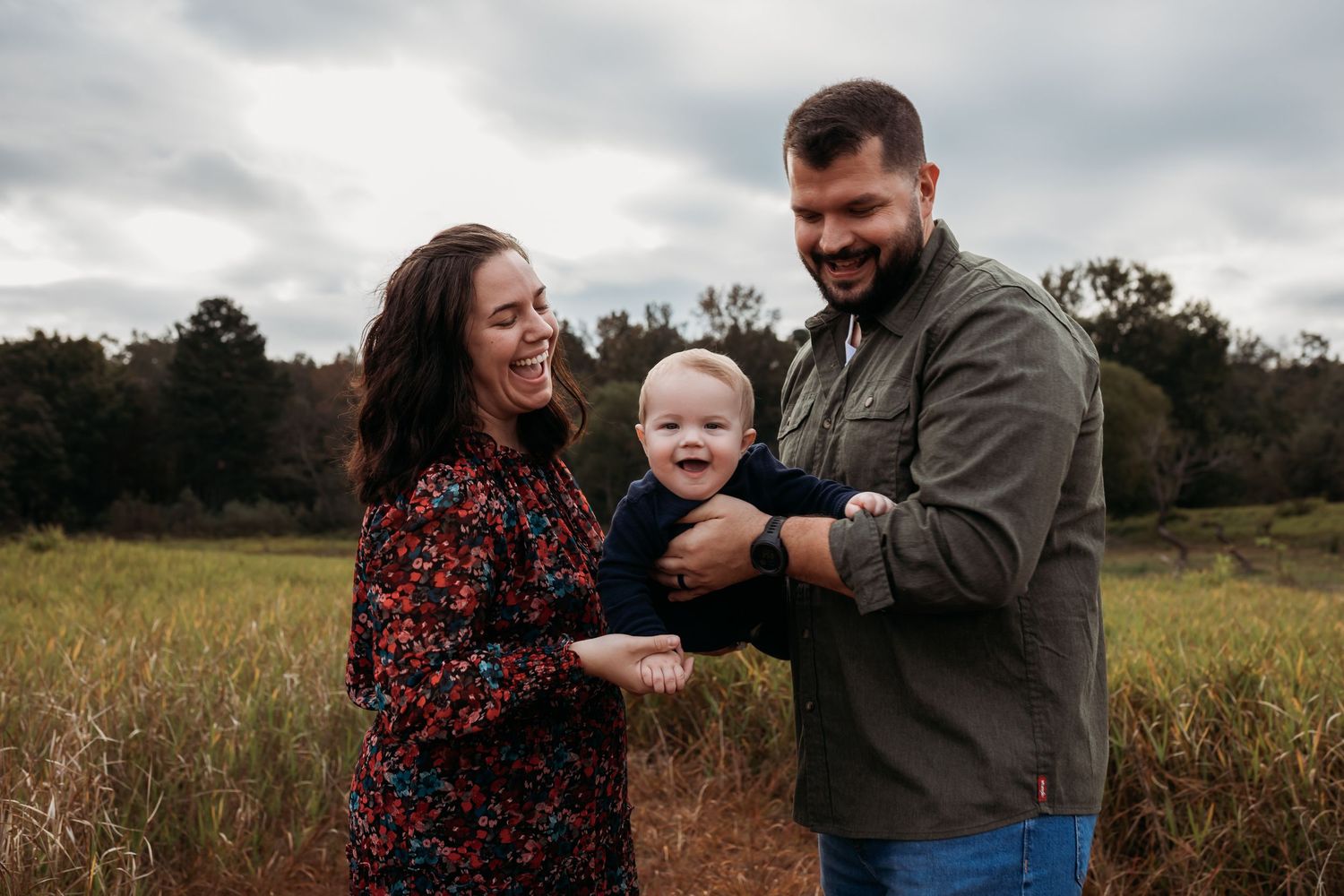 Cullman Alabama Family Photographer. family shares joyful moments together in a golden autumn field during an outdoor photo session.