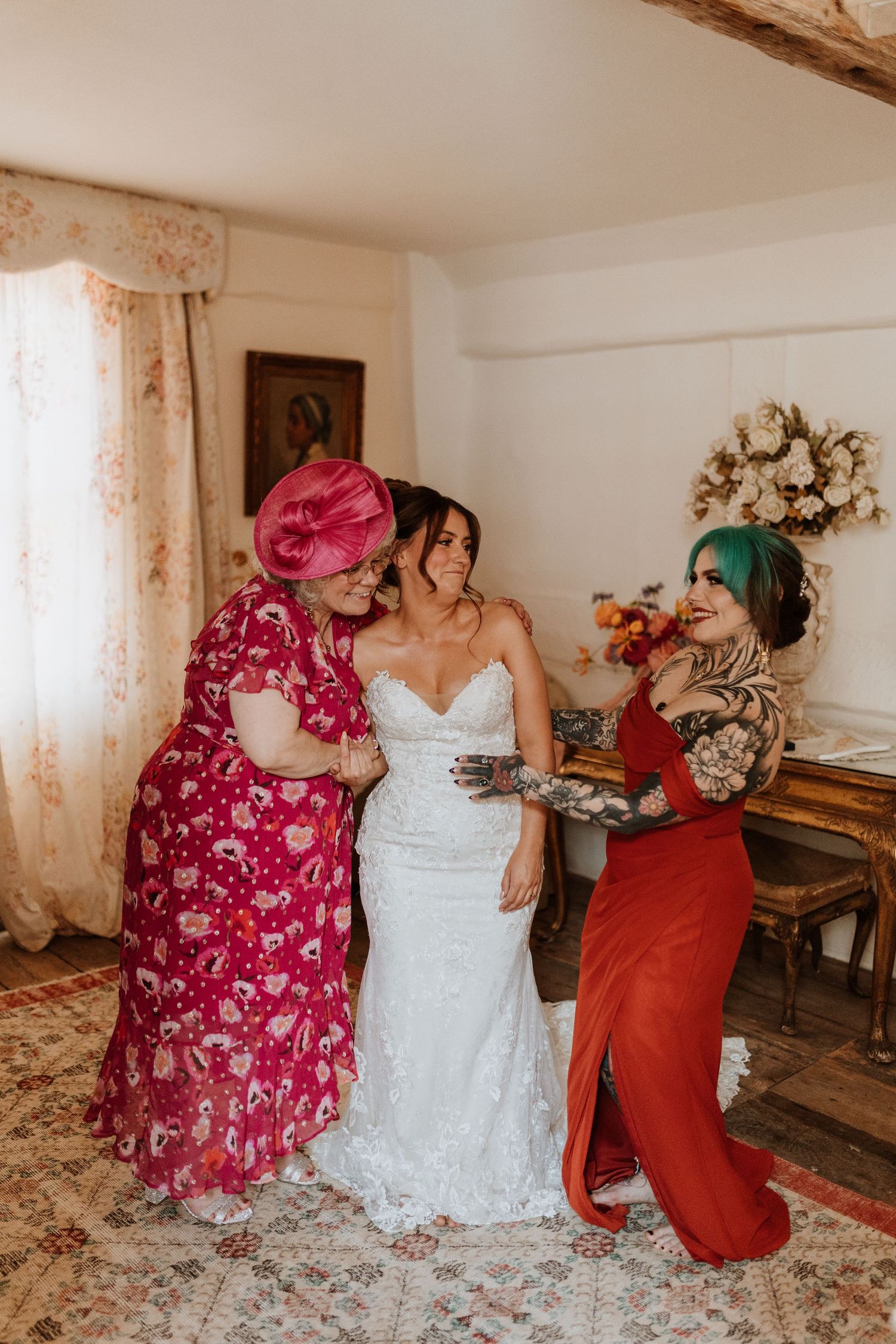 A candid moment showing bride, sister and mum in a room before wedding at Lyde Court, Hereford.