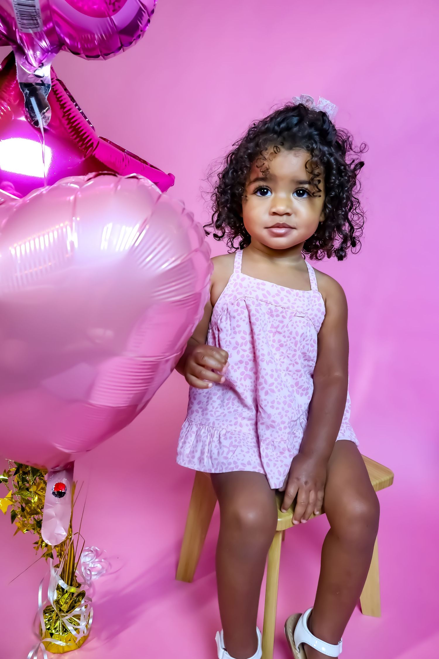 Second birthday celebration with pink star balloons and sparkly decorations.