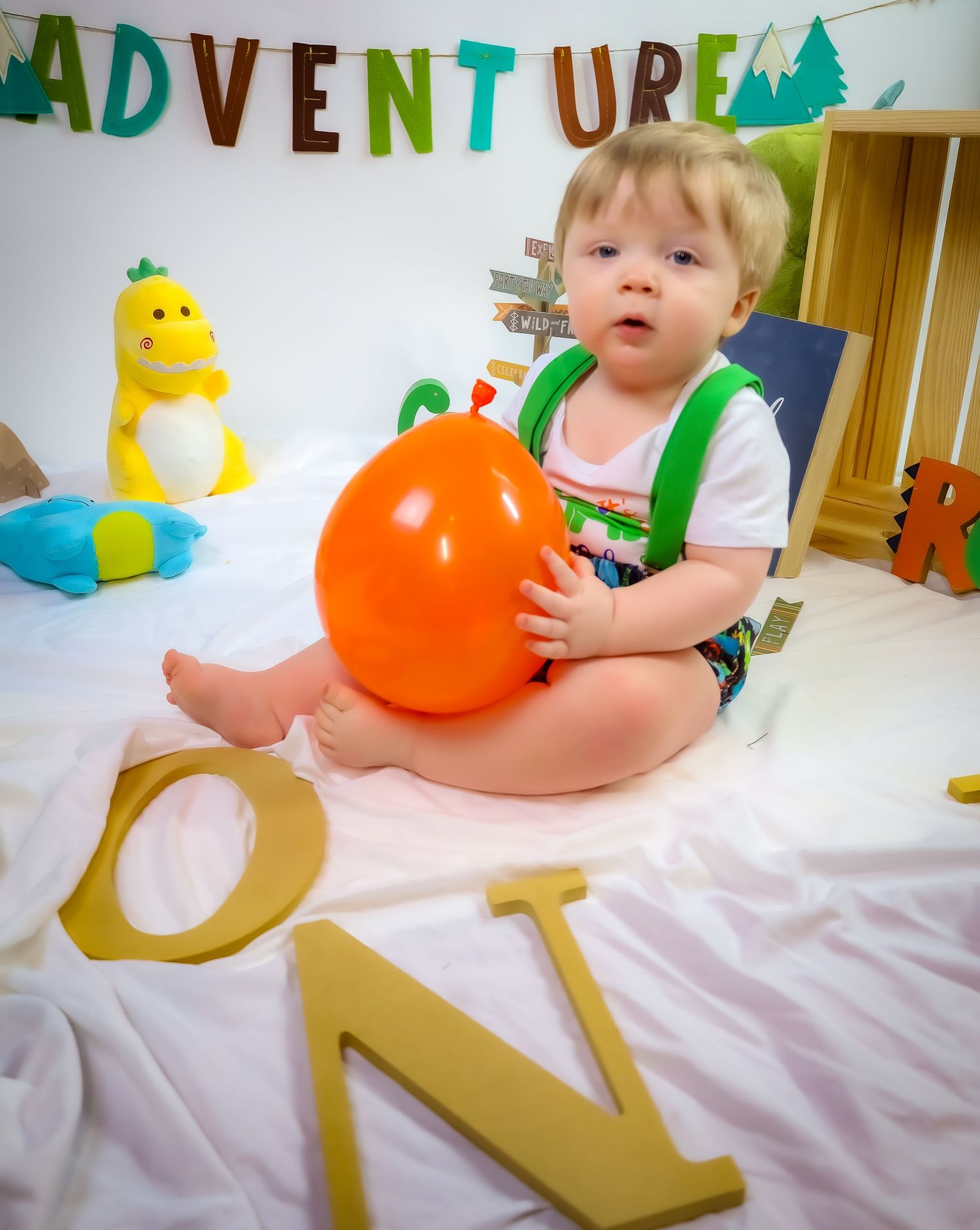 Adventure-themed setup with orange balloon and decorative letters against white background.