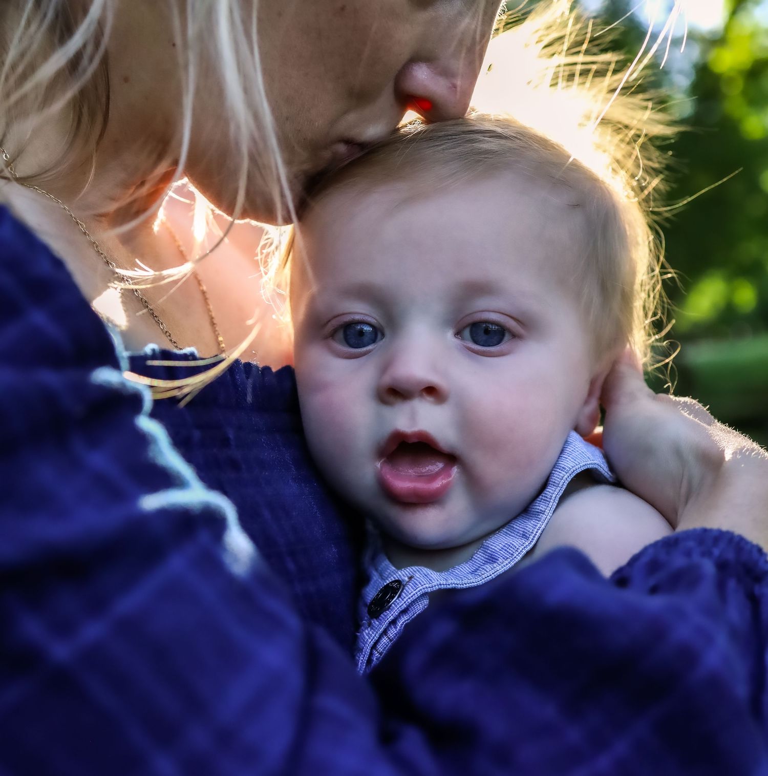 Candid expressions captured in natural sunlight with bokeh effect.