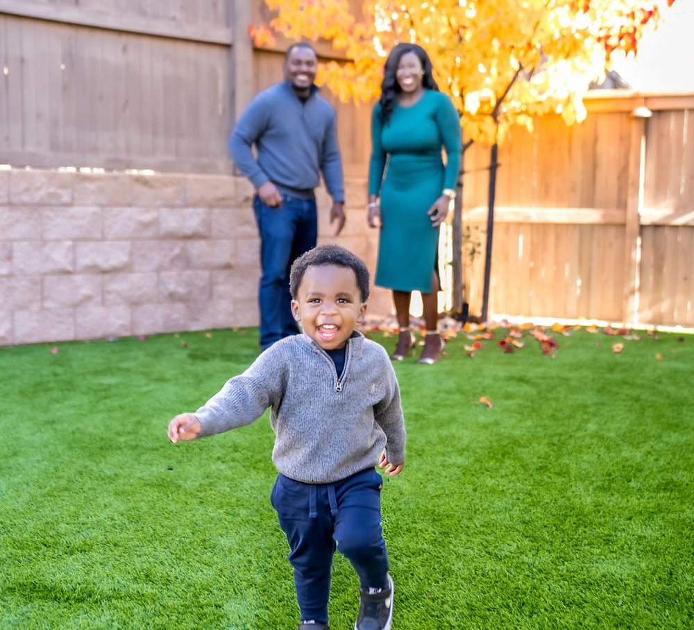 A series of playful outdoor moments captured against a backdrop of fall foliage and a wooden fence.
