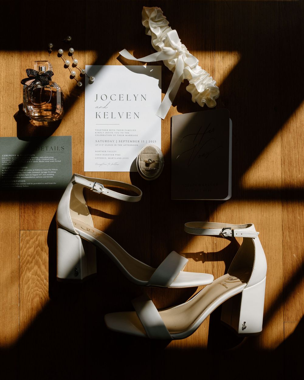Wedding stationery and invitation cards arranged artistically with shadows on a wooden surface.