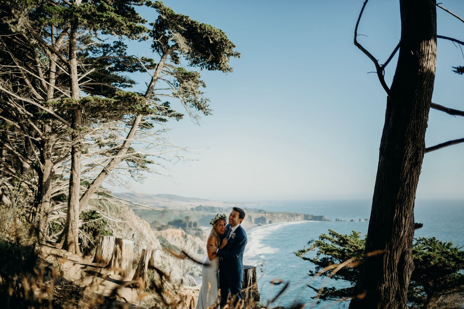 Coastal wedding photos with dramatic cliffside ocean views in California.
