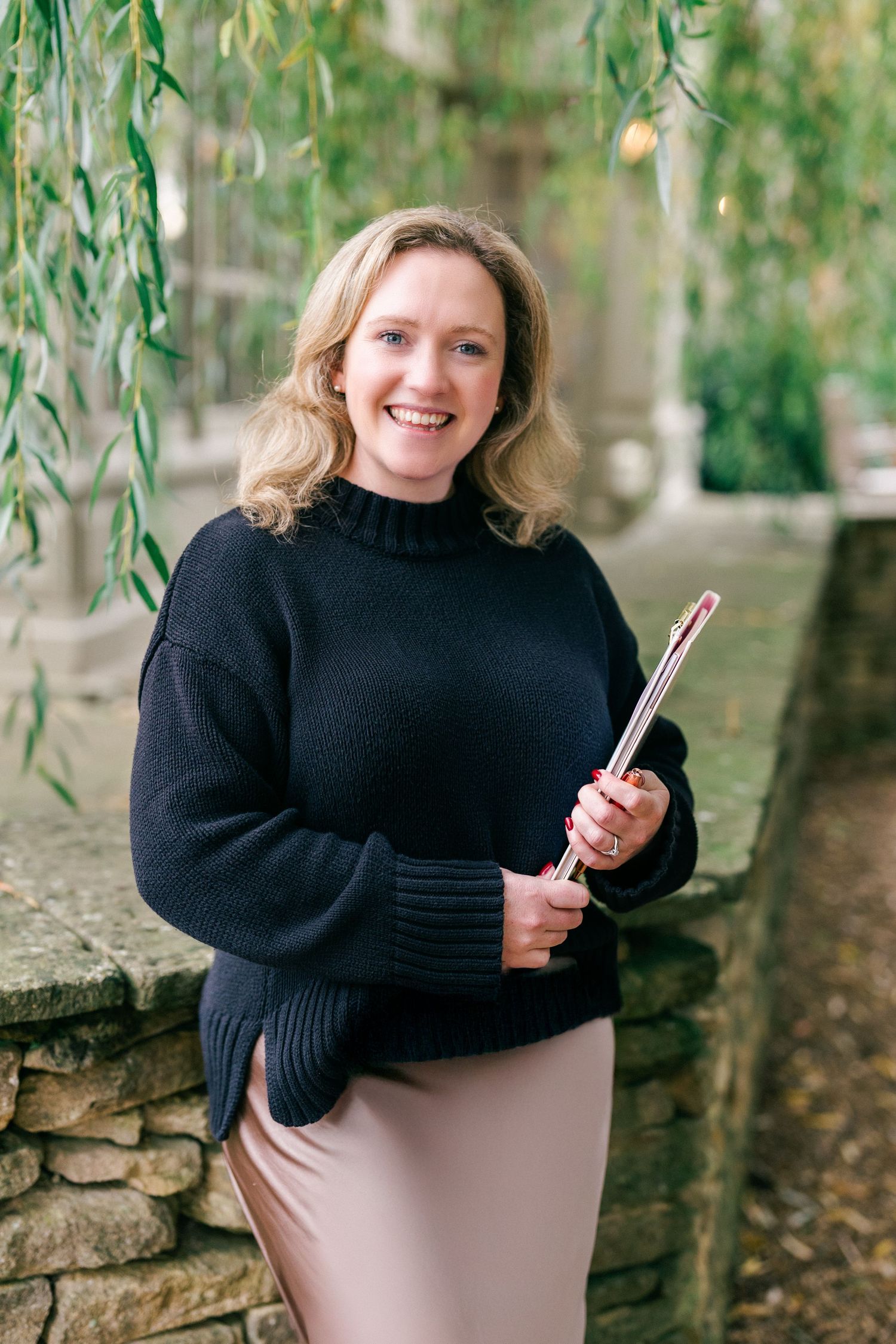 Lifestyle headshot of a woman standing outdoors in natural light
