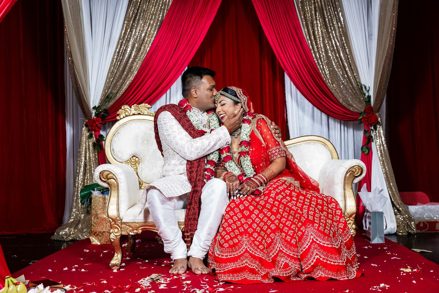 A collage of traditional Indian wedding scenes with red and gold decor showing couples during their marriage ceremony.