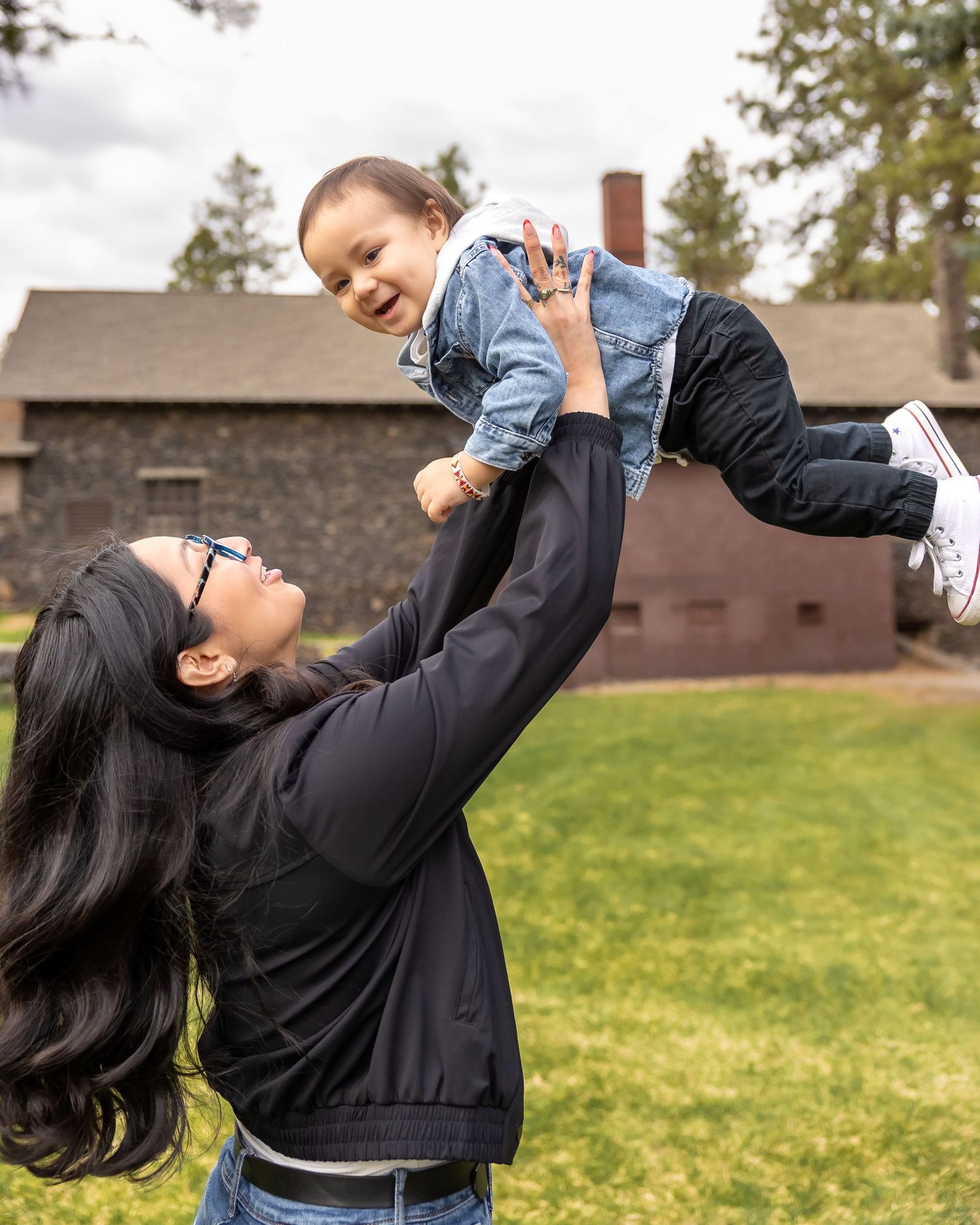 A sequence of joyful outdoor photos showing a parent playfully lifting and swinging a small child in the air.
