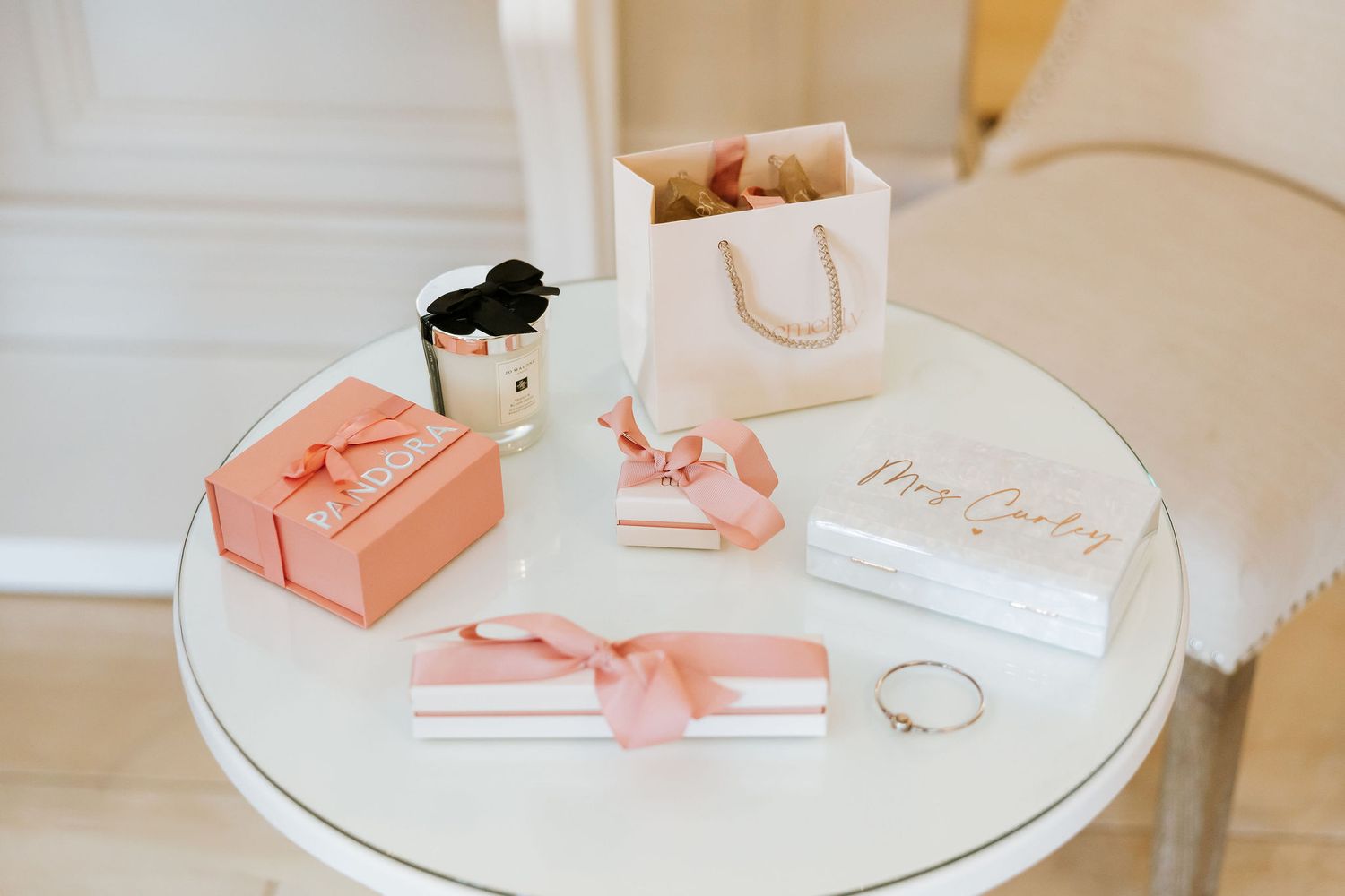 A series of images showing pink and white objects arranged on a white table surface in a minimalist style.
