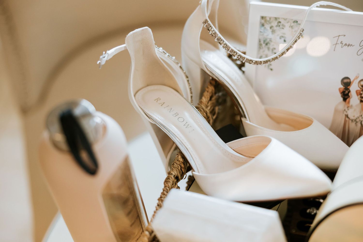 A collection of elegant white bridal shoes displayed in a boutique setting with soft lighting and neutral decor.