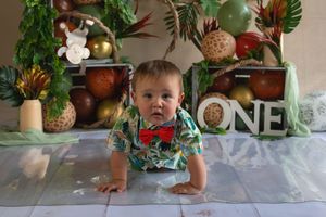 A sequence of photos showing someone crawling under a white tablecloth at a festively decorated holiday table.