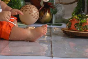 A sequence of hands kneading and rolling dough on a floured wooden surface during food preparation.