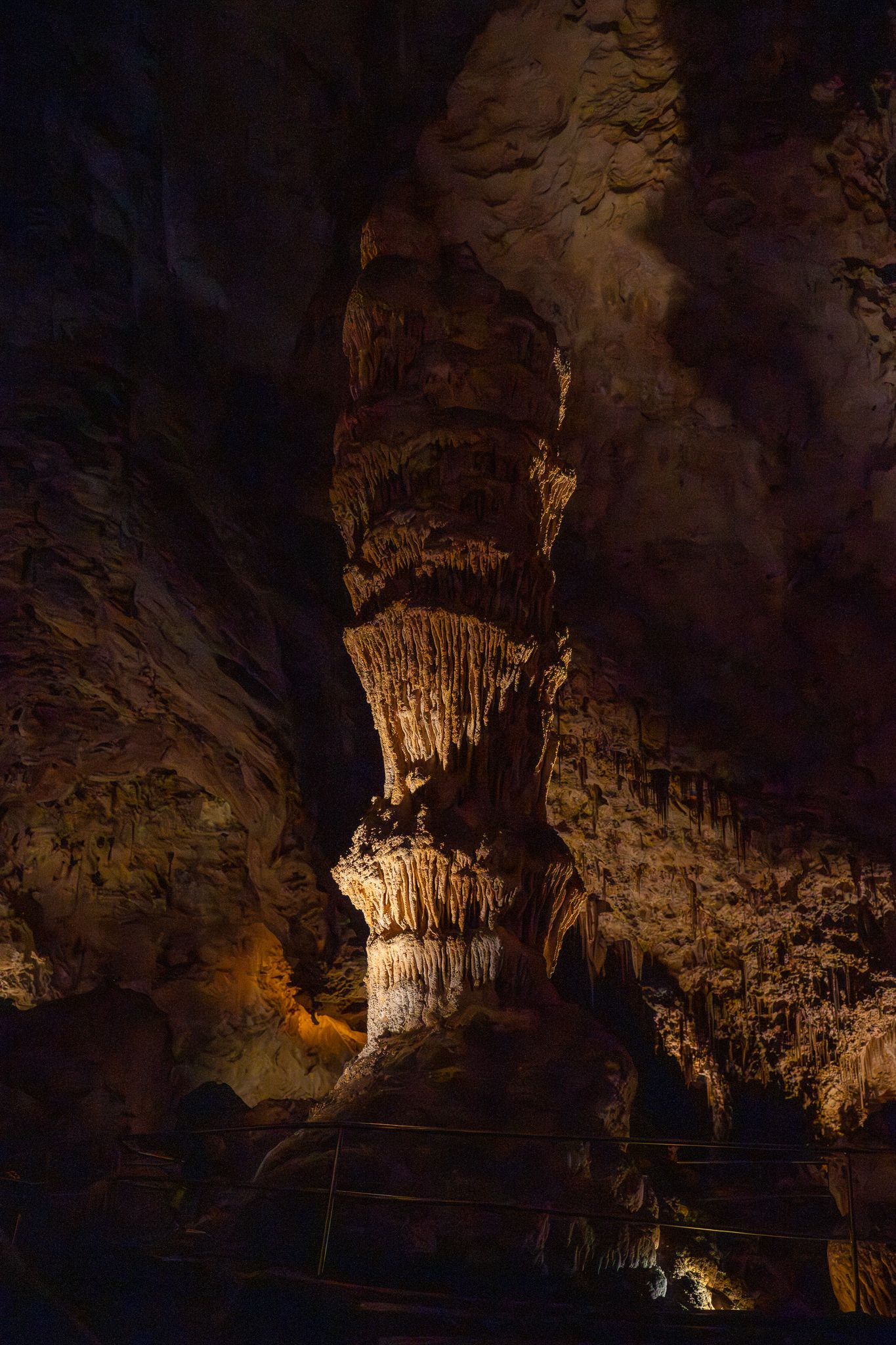 Dramatic limestone formations and stalactites illuminated inside Carlsbad Caverns National Park's natural underground cave system.