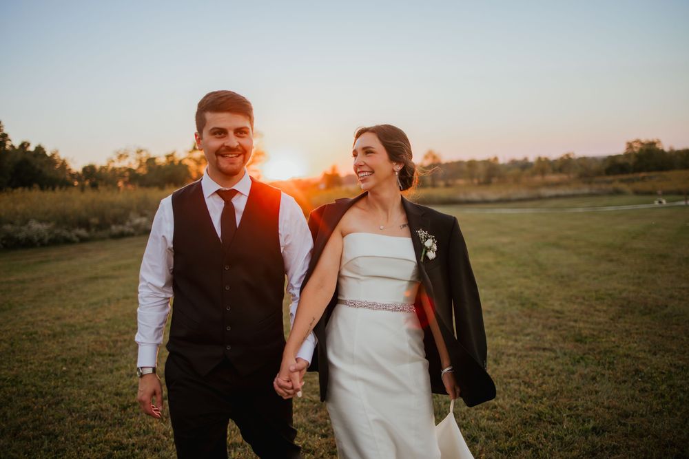 Bride and groom, holding hands and walking at Sunset in Zionsville, Indiana