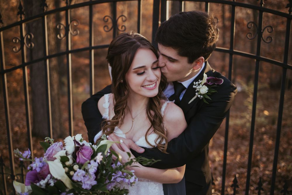 Bride and groom, kissing at sunset at the Bluffs at Connor Prairie, located in fishers Indiana