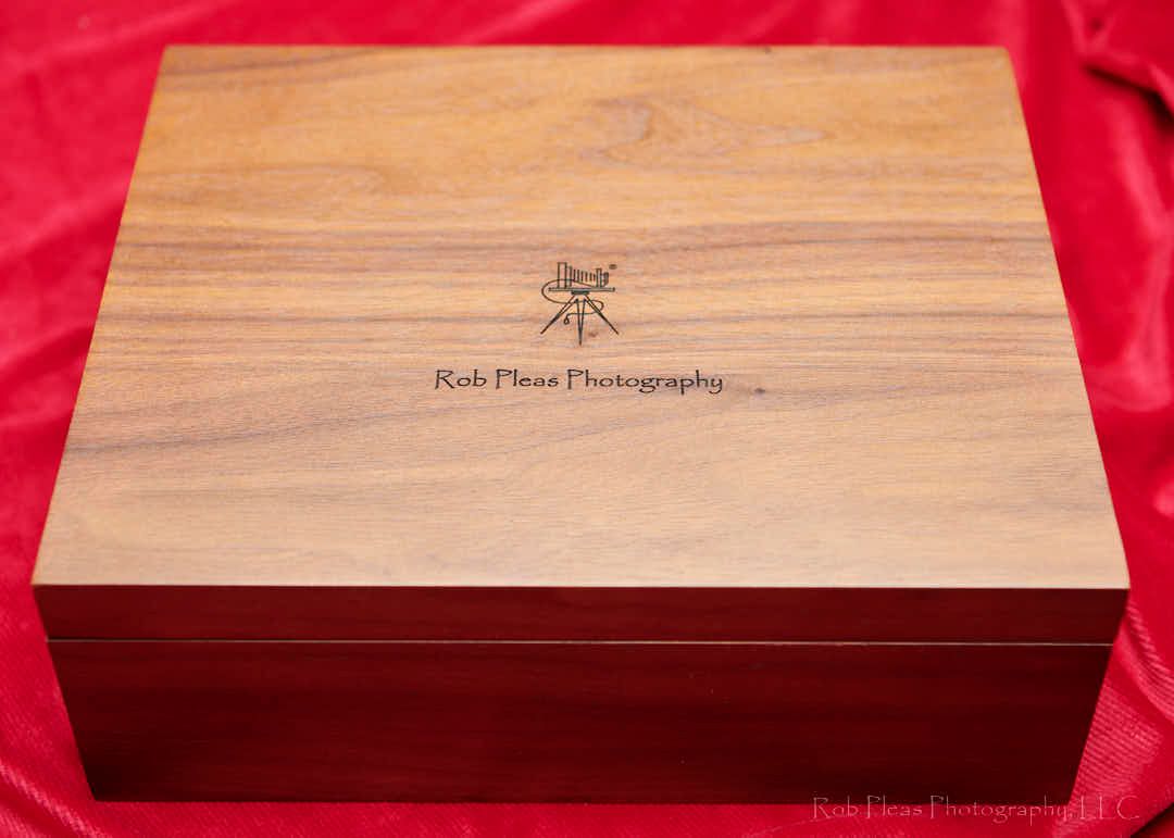 Premium walnut folio box from Rob Pleas Photography, LLC.  Top view showing name and logo engraved onto lid of box.