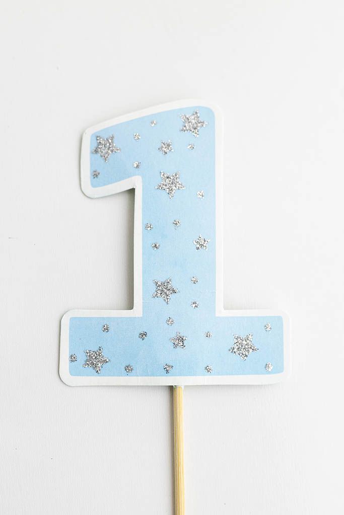 Blue number 1 cake topper with silver glitter star decorations;  for 1st birthday photoshoot in Menifee.