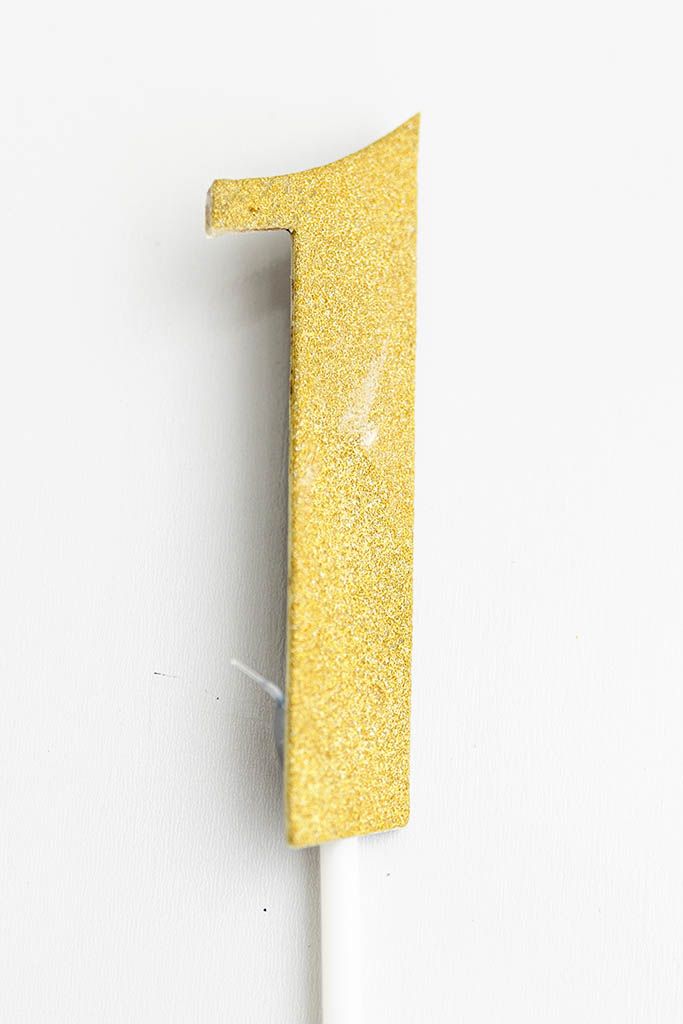 Gold glitter number one cake topper.